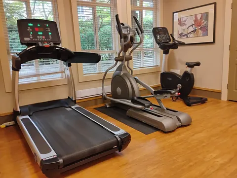 Exercise room with a treadmill, elliptical machine and stationary bicycle