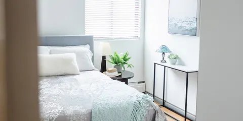 Bedroom with a bed, bedside tables and a window.