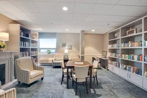 Library with bookshelves, armchairs and a table