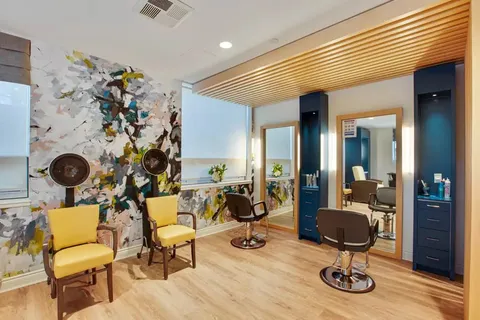 Hair salon with styling chairs, mirrors and hair dryers