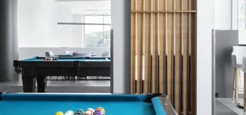 Billiards tables beside windows and wooden partitions