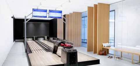 Bowling lanes with scoring screens and ball-return equipment