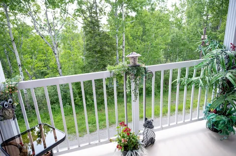 Private balcony with a table and outdoor chairs.