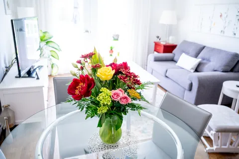 Suite living area with a sofa and floral arrangement.