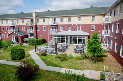 Residence buildings overlooking a paved courtyard.
