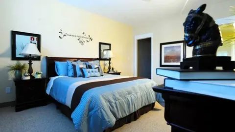 Bedroom with a bed, television and bedside tables.