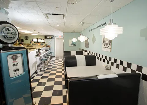 Diner area with booths, stools and a service counter.