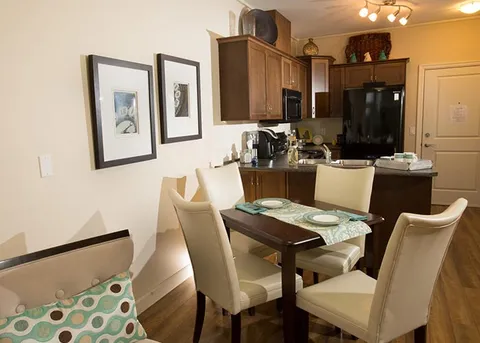 Suite dining table beside a kitchenette.