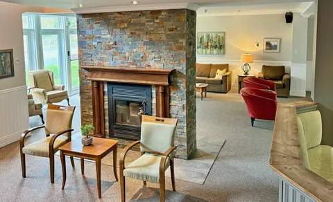 Lounge seating around a stone fireplace.