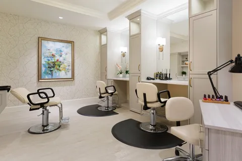 Salon with styling chairs and mirrors.