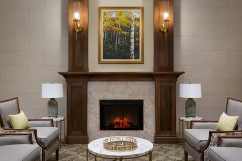 Fireside lounge with armchairs and a coffee table.