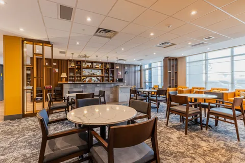 Shared room with tables, chairs and a bar counter.