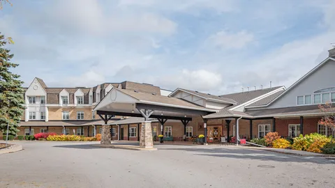 Residence building with a covered driveway entrance and flower beds