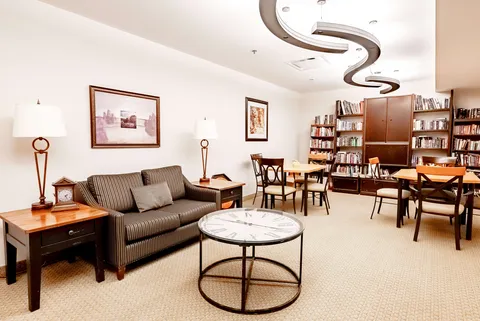 Sofa and tables beside bookshelves