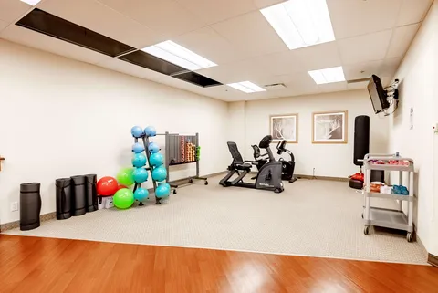 Exercise bikes, balls and weights in a fitness room