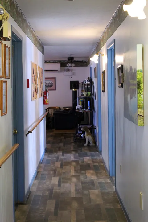 Interior corridor with blue doors and patterned flooring.