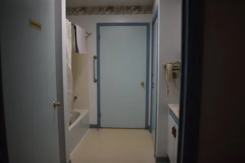 Bathroom entrance showing a shower and washroom door.