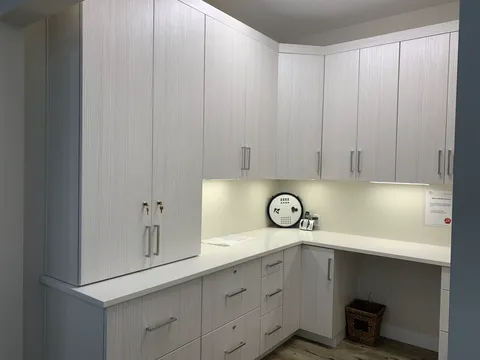 Communal kitchen with white cabinets and an island.
