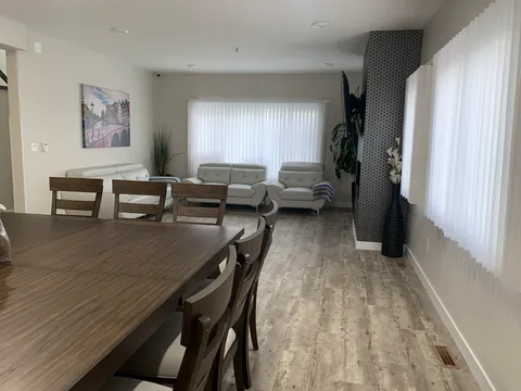 Living room with a sectional sofa and large windows.