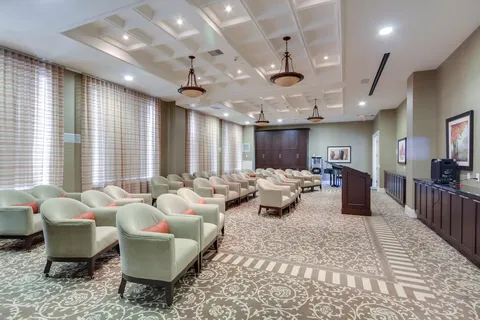 Room with rows of armchairs facing the front of the room