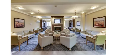 Lounge with sofas, armchairs, a fireplace and wall-mounted television