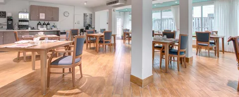 Dining room with wooden tables, chairs and a counter