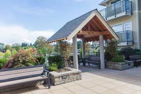 Courtyard with a gazebo and garden beds.