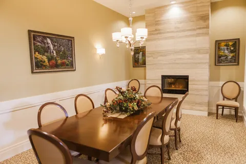 Private dining room with a long table and fireplace.