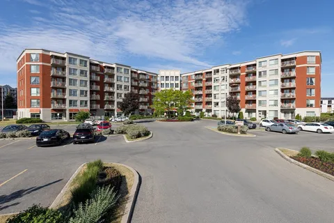 Residence buildings with balconies around a paved parking area