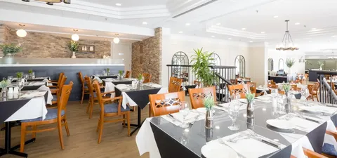 Dining room with set tables, chairs and ceiling lights