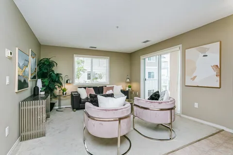 Room with armchairs beside windows and a round glass table