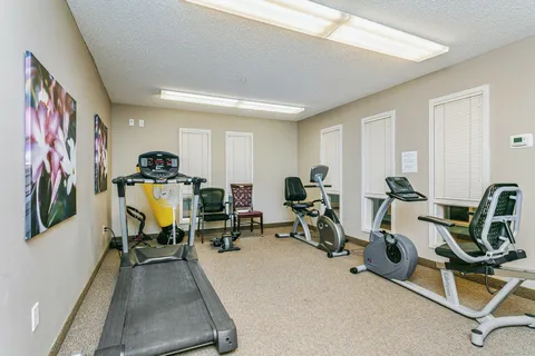Fitness room with a treadmill and exercise bicycles