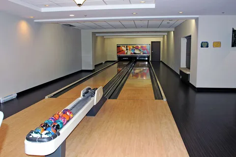 Indoor bowling lanes with a ball return.