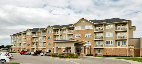 Multi-storey residence with balconies and a covered entrance.