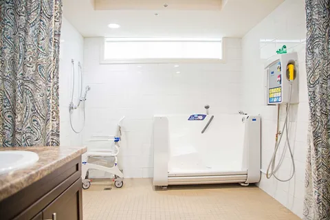 Therapeutic bathing room with accessible bathtub and shower.