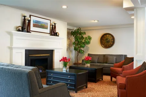 Room with sofas, armchairs, a coffee table and a fireplace