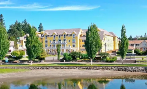 Yellow residence building viewed across the waterfront.