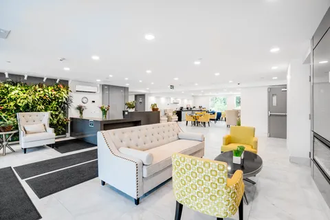 Lounge with sofas, armchairs and a plant wall.