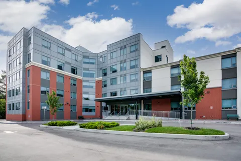 Residence building beside a paved entrance drive.