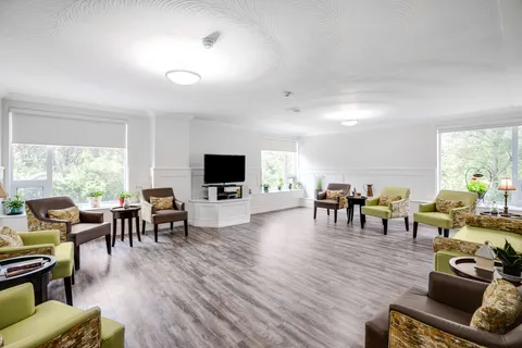 Common lounge with armchairs and a television.