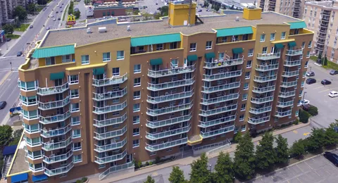 Aerial view of the residence with balconies and surrounding streets.