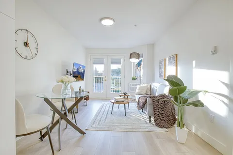 Suite living area with upholstered seating and glass dining furniture.