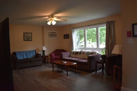 Sitting room with sofas, coffee table and a large window.