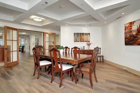 Private dining room with a wooden table, chairs and upholstered seating.