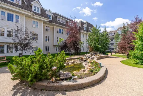 Residence building beside landscaped paths and garden beds