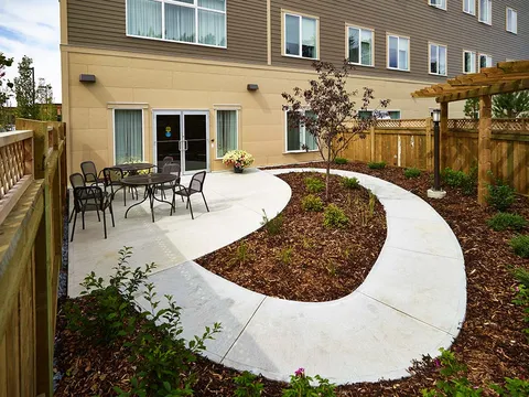 Courtyard patio with tables, chairs and planted beds