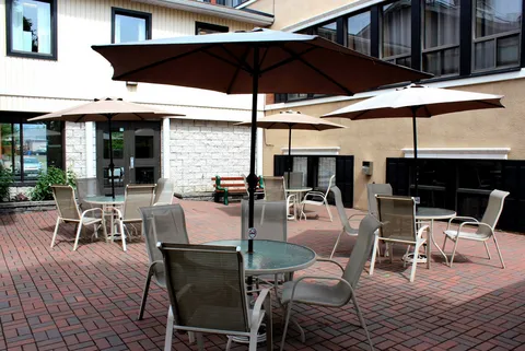 Brick patio with tables, chairs and parasols