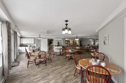 Dining room with wooden tables, chairs and a serving counter