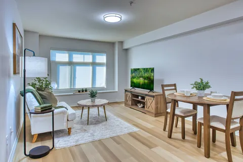 Suite living and dining area with a sofa and wooden furniture