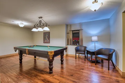 Games room with a pool table and cue rack